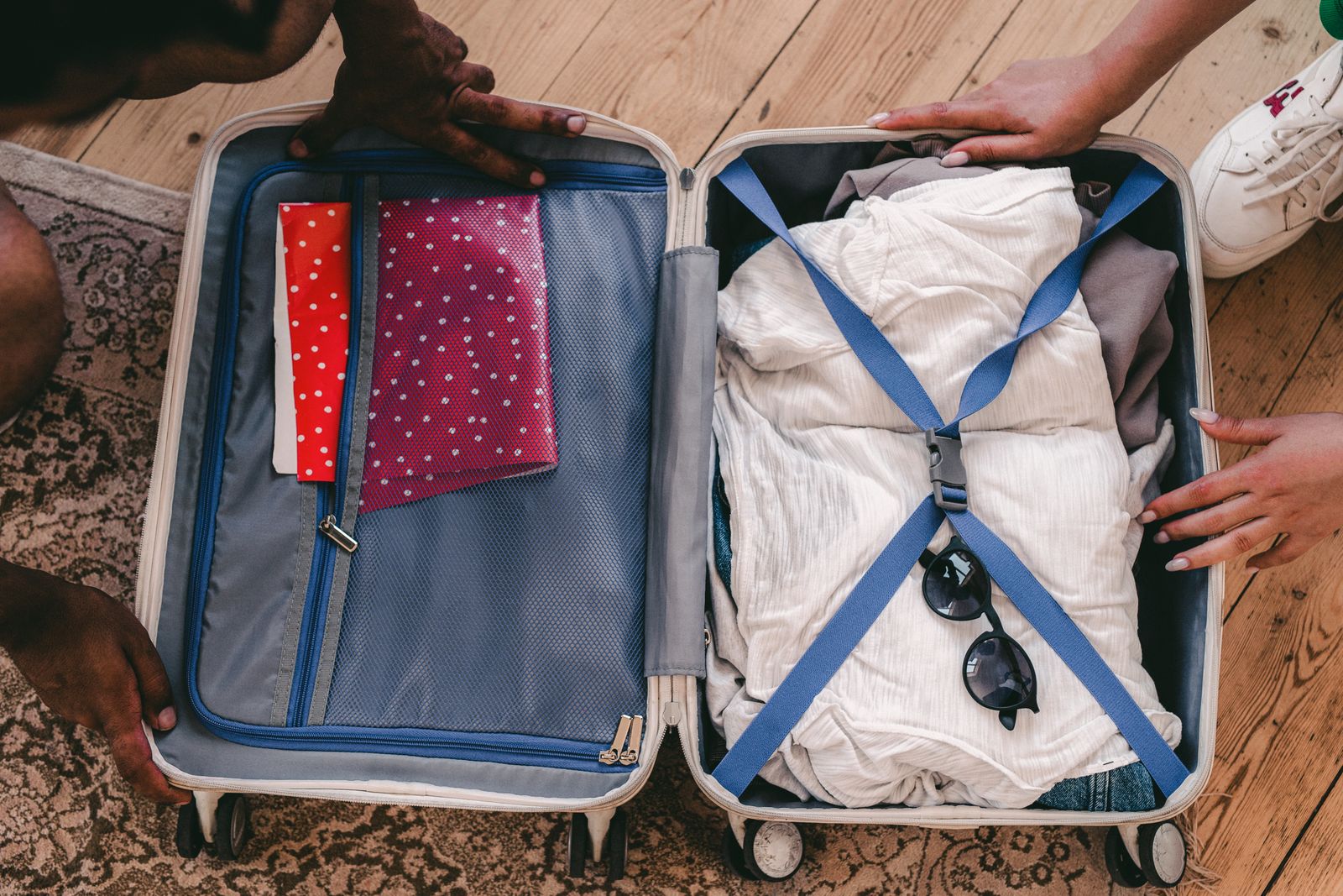 An open suitcase is arranged with folded clothing and travel essentials for a short trip.