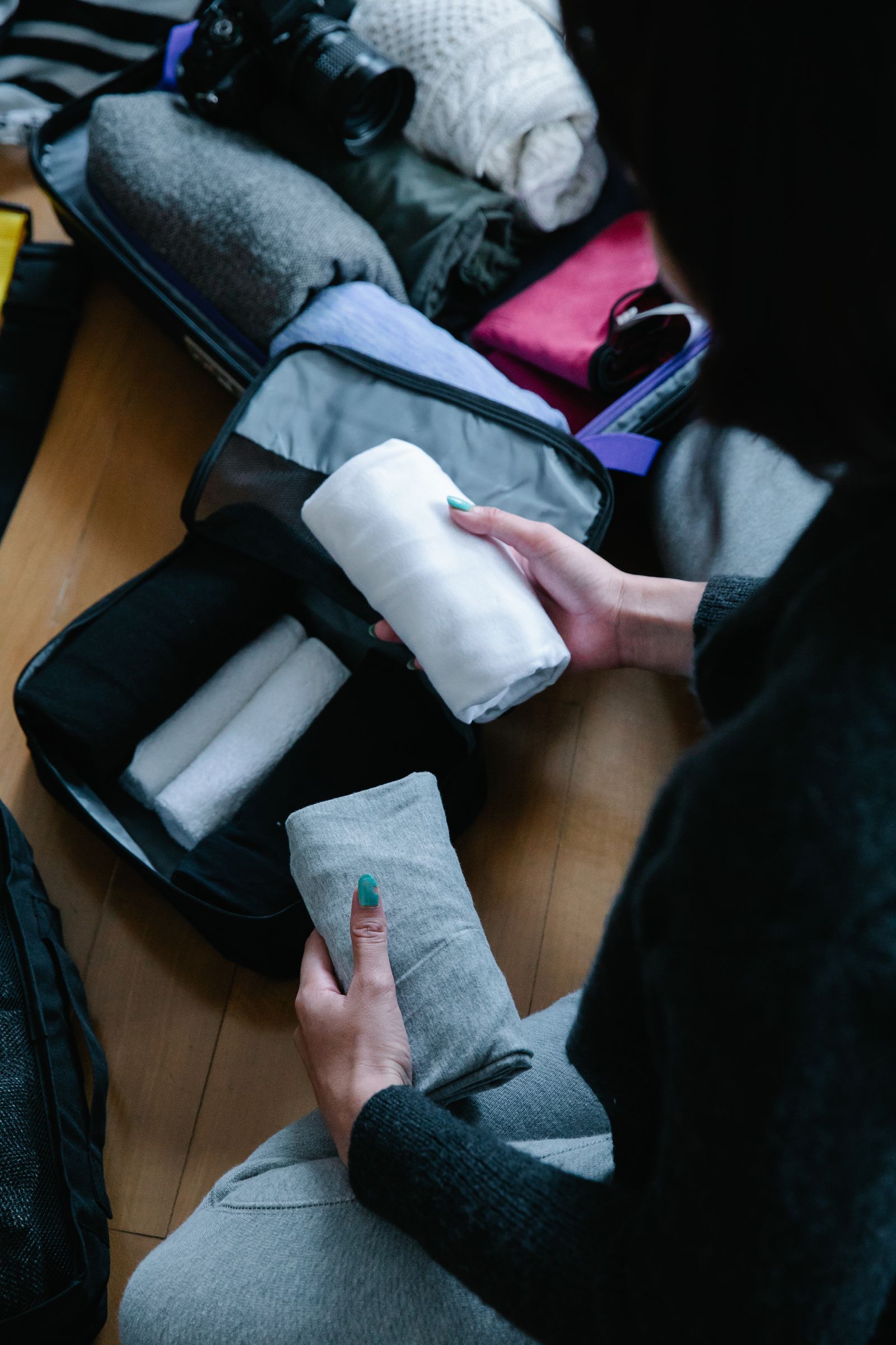Folded clothing is organized inside luggage, illustrating a compact packing approach for a short trip.