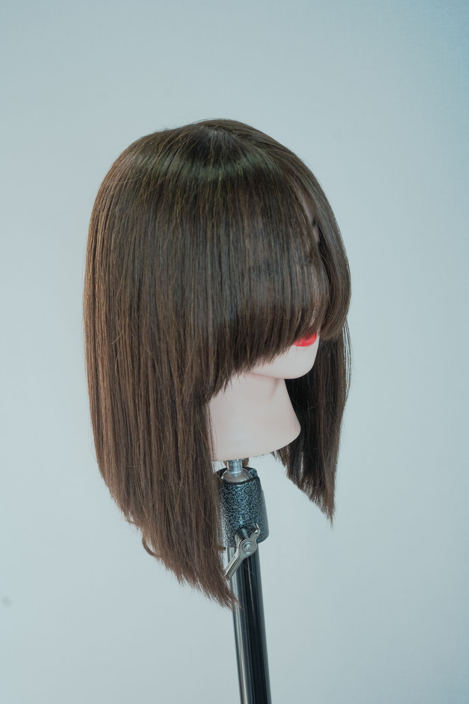 A wig on a mannequin shows the fall and texture of a finished style; it is not labeled as human hair or synthetic fiber.